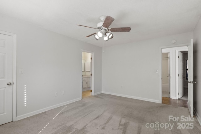 unfurnished bedroom with ceiling fan, carpet floors, and connected bathroom