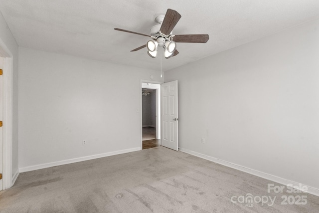 spare room featuring ceiling fan and light colored carpet