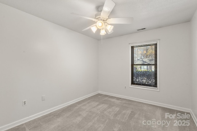 empty room with light colored carpet and ceiling fan