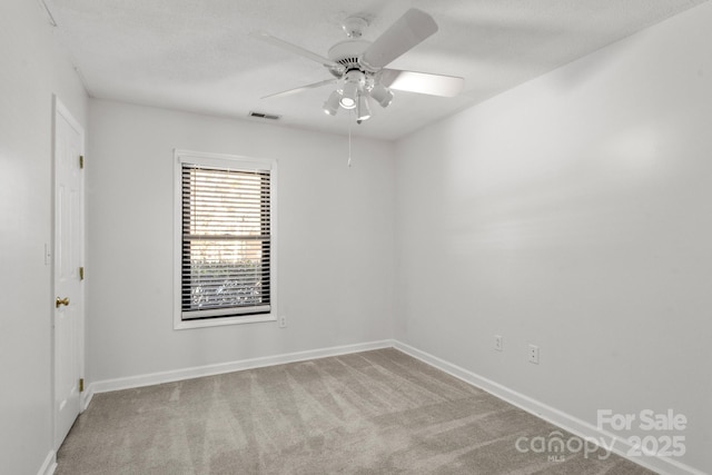 empty room featuring light carpet and ceiling fan