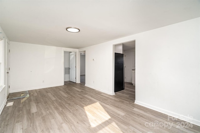 spare room featuring light hardwood / wood-style floors