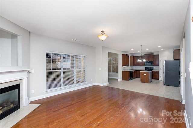 unfurnished living room with light hardwood / wood-style flooring and a high end fireplace