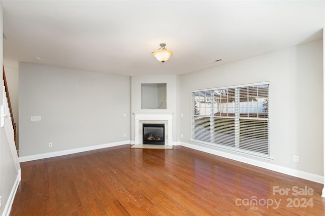 unfurnished living room with hardwood / wood-style floors