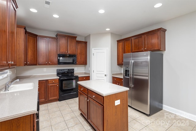 kitchen featuring black appliances, a kitchen island, light tile patterned floors, and sink