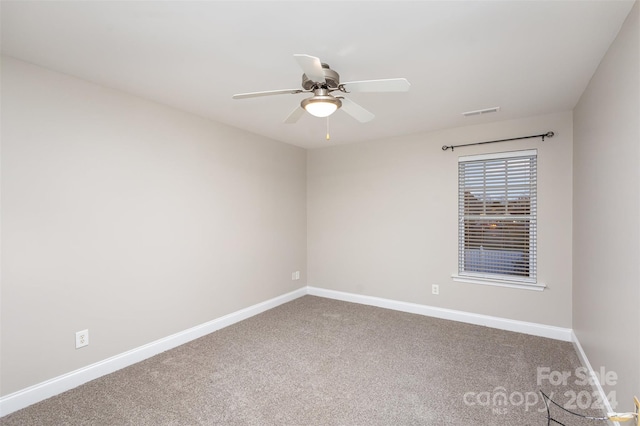 carpeted spare room featuring ceiling fan