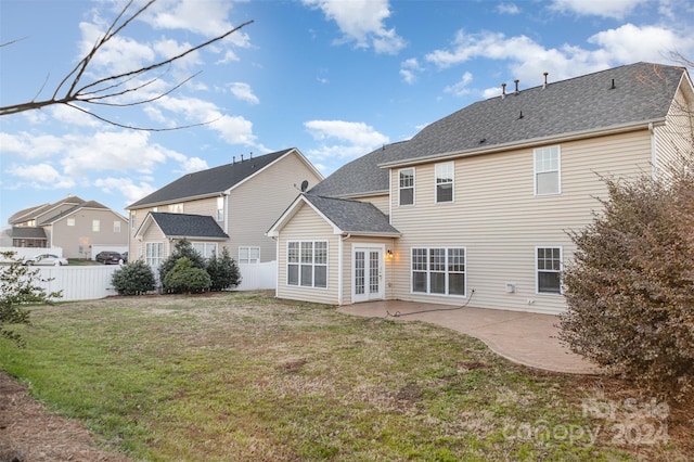 back of property featuring a lawn and a patio