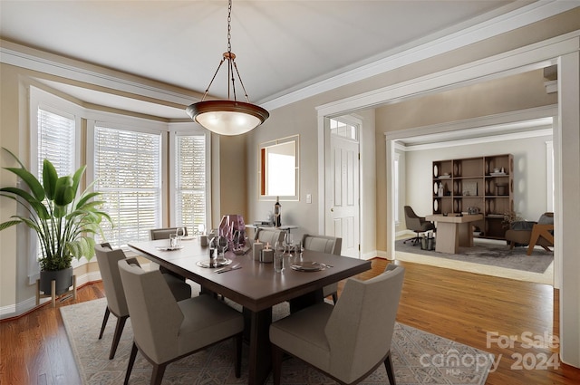 dining area with hardwood / wood-style flooring and ornamental molding