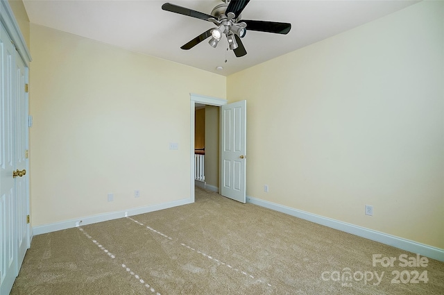 unfurnished bedroom with light carpet and ceiling fan