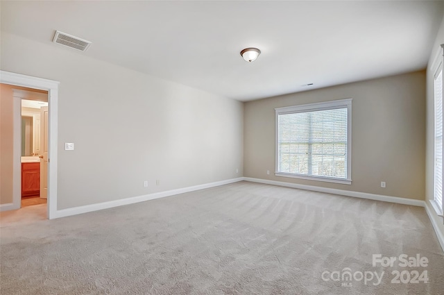 unfurnished room with light colored carpet