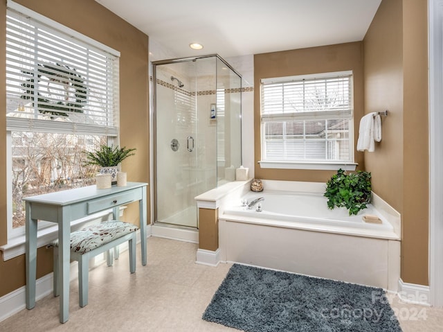 bathroom featuring shower with separate bathtub