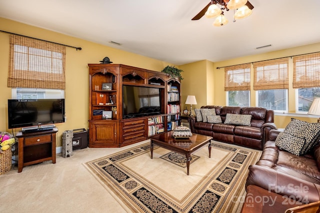 living room featuring ceiling fan and light colored carpet