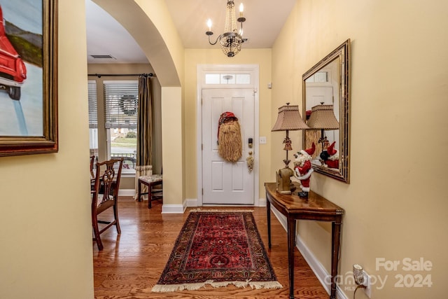 entrance foyer with dark hardwood / wood-style flooring and a chandelier