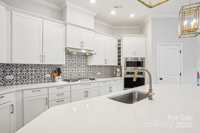 kitchen with crown molding, white cabinetry, sink, and appliances with stainless steel finishes