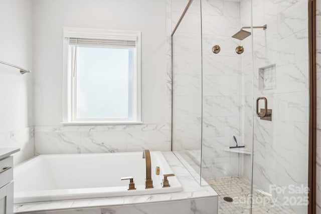 bathroom featuring vanity and independent shower and bath