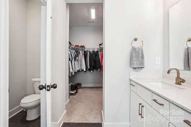 bathroom featuring vanity and toilet