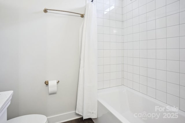 bathroom featuring shower / bath combo and toilet