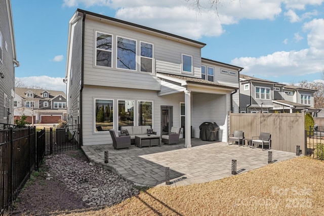 rear view of property featuring a patio area and an outdoor hangout area