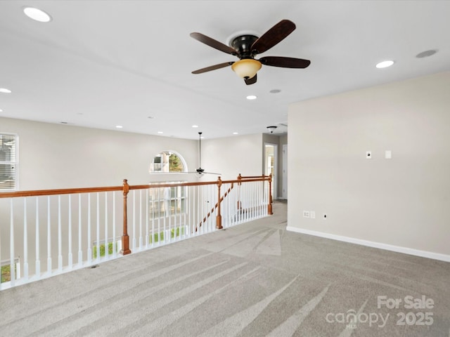 carpeted empty room featuring ceiling fan