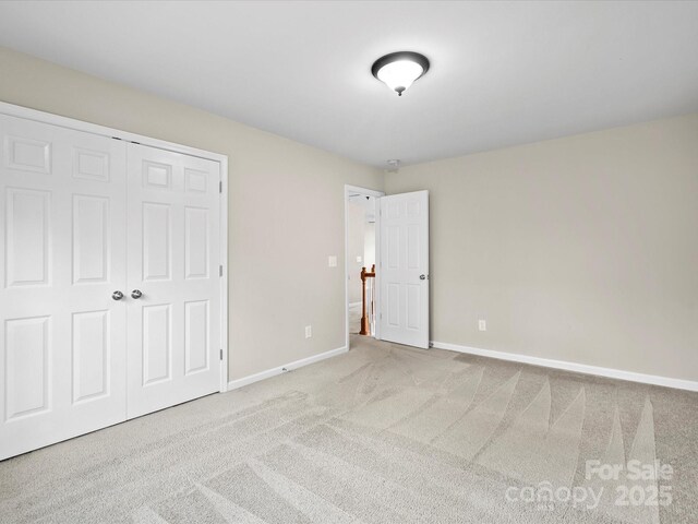 unfurnished bedroom with a closet and carpet