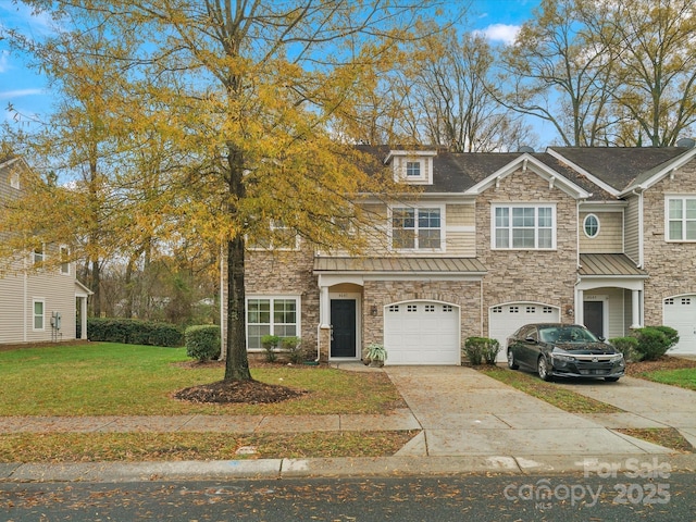 view of front of house featuring a front yard and a garage