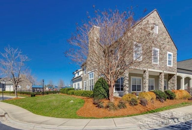 view of side of property with a yard