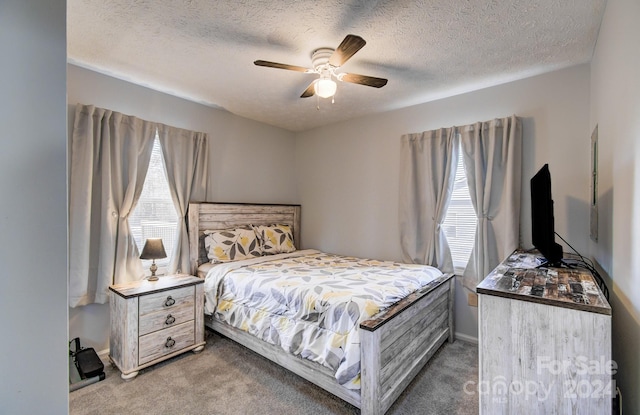 bedroom featuring carpet flooring, multiple windows, and ceiling fan