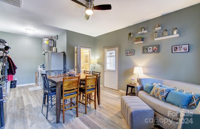 dining area with ceiling fan and light wood-type flooring