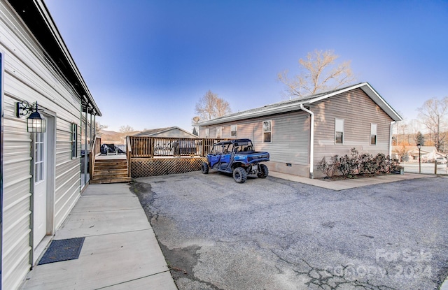 view of side of home with a deck