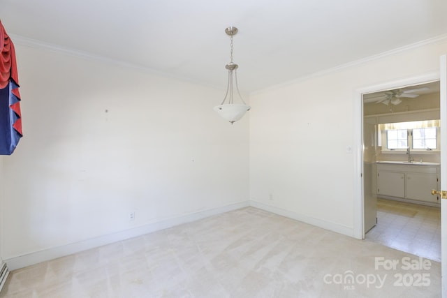 unfurnished room with light colored carpet, ceiling fan, ornamental molding, and sink