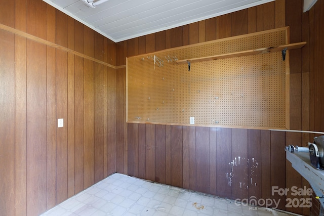 empty room featuring wood walls