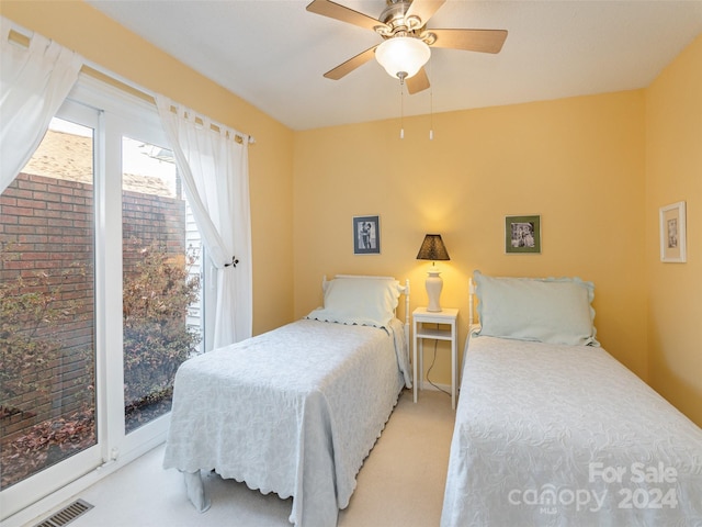 carpeted bedroom featuring access to outside and ceiling fan