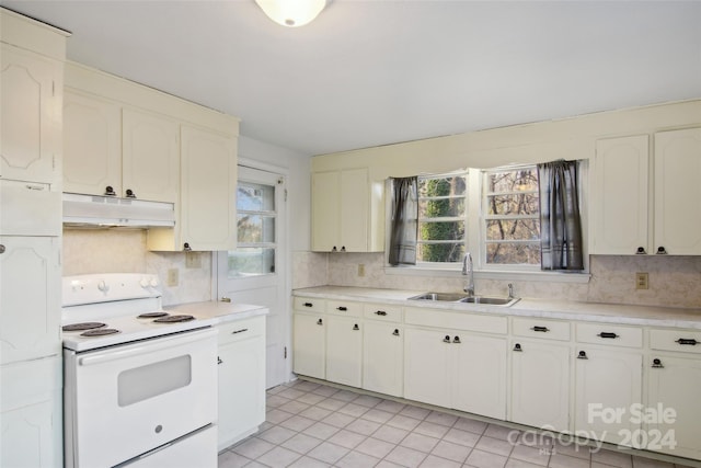 kitchen featuring white cabinetry, sink, tasteful backsplash, electric stove, and light tile patterned flooring