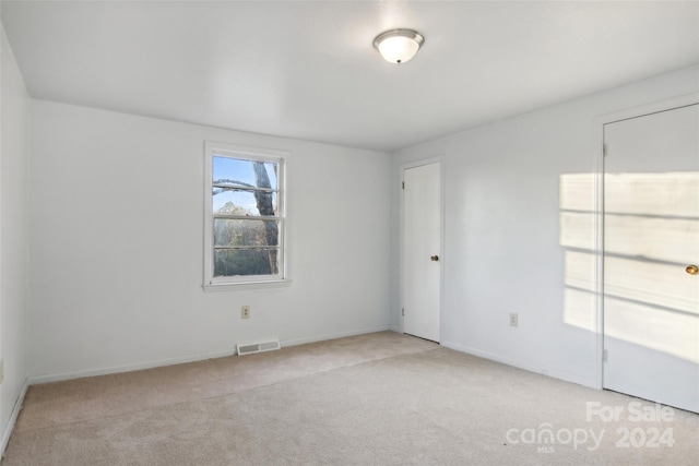 spare room with light carpet