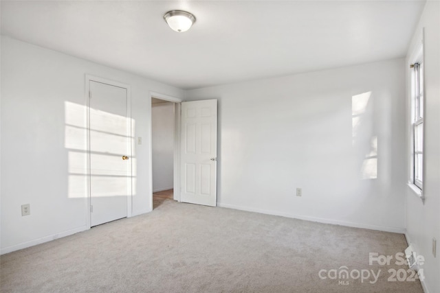 empty room with plenty of natural light and light carpet