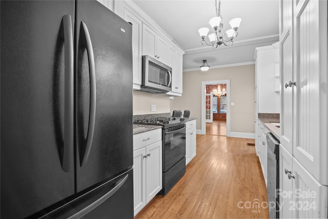 kitchen featuring light wood-type flooring, stainless steel appliances, white cabinetry, and crown molding