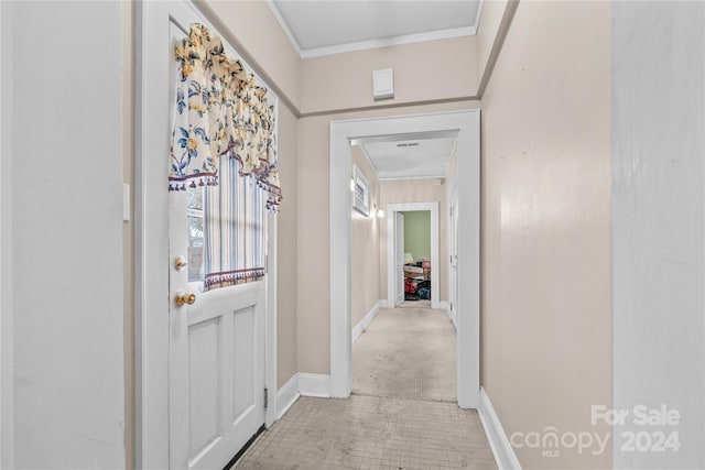 hall featuring light colored carpet and crown molding