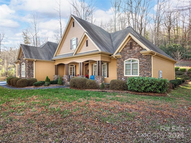 view of front of home featuring covered porch and a front yard