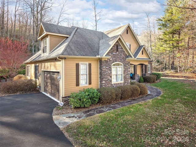 view of side of property featuring a lawn and a garage