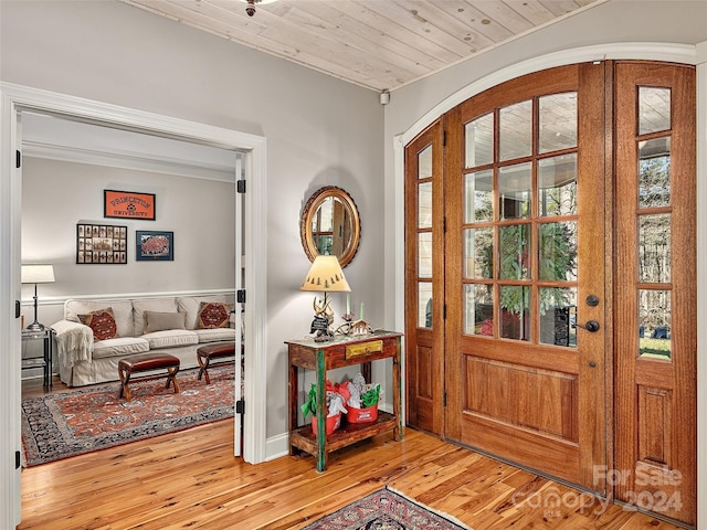 entrance foyer with light wood-type flooring and wooden ceiling