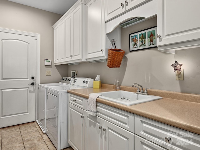 clothes washing area with cabinets, separate washer and dryer, sink, and light tile patterned floors