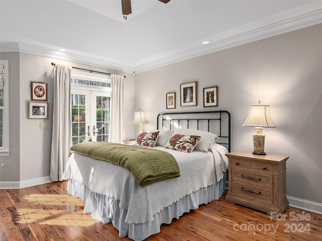 bedroom featuring french doors, light hardwood / wood-style floors, ceiling fan, and crown molding