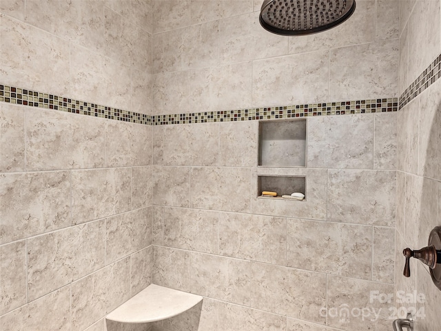 bathroom with a tile shower