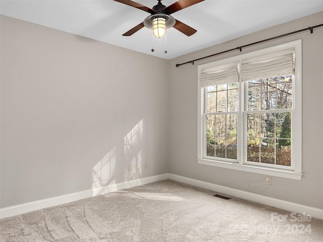 empty room featuring carpet and ceiling fan