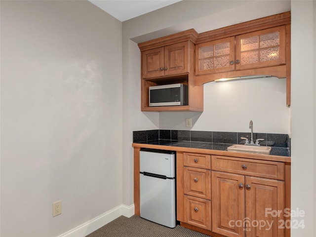 kitchen featuring white fridge and sink