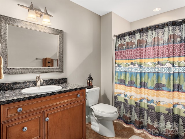 bathroom with tile patterned floors, vanity, toilet, and walk in shower