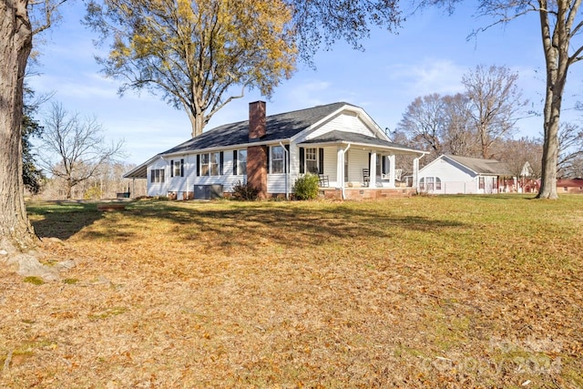 single story home with a porch and a front yard