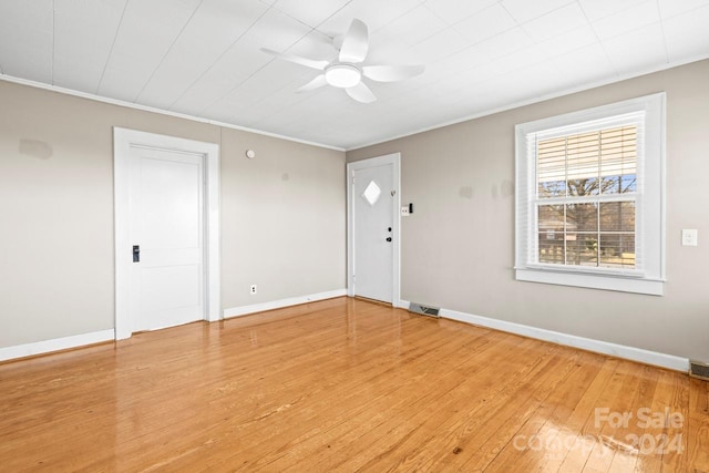 spare room featuring hardwood / wood-style flooring, ceiling fan, and ornamental molding