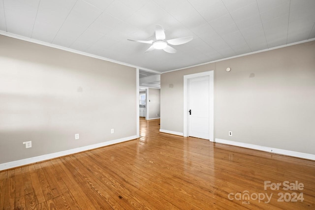 spare room featuring hardwood / wood-style flooring, ceiling fan, and crown molding