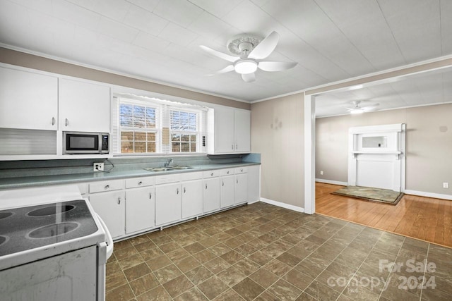 kitchen featuring crown molding, sink, white stove, dark hardwood / wood-style floors, and white cabinetry