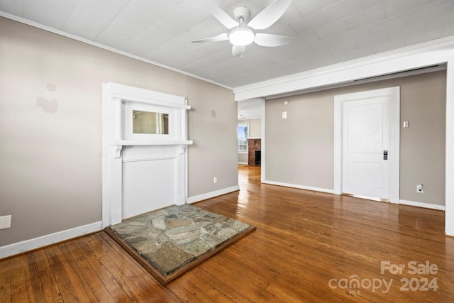 unfurnished living room featuring hardwood / wood-style floors, ceiling fan, and ornamental molding